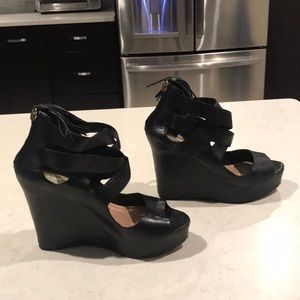 Black leather wedges with criss-cross straps